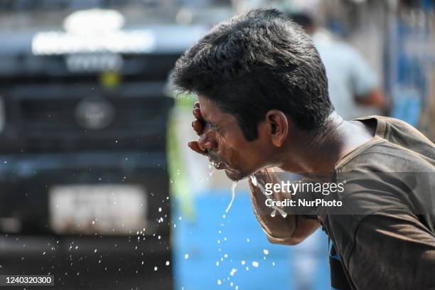 Man is seen splashing water on his face to escape from severe heat wav in Kolkata , India , on 29 April 2022 . Indian meteorological department has...