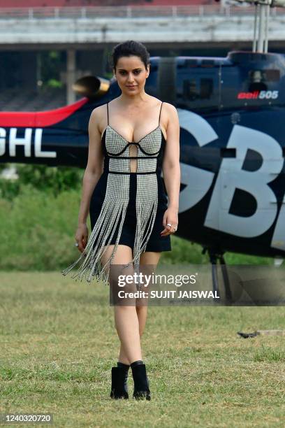 Bollywood actress Kangana Ranaut poses after arriving in a helicopter to attend a promotional event for her upcoming movie Dhaakad at the Mahalaxmi...