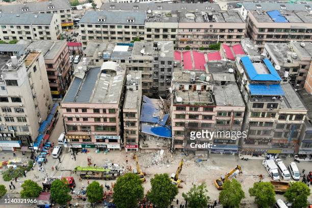 This aerial photograph taken on April 29, 2022 shows rescuers working after a six-storey building collapsed in Changsha, in China's central Hunan...