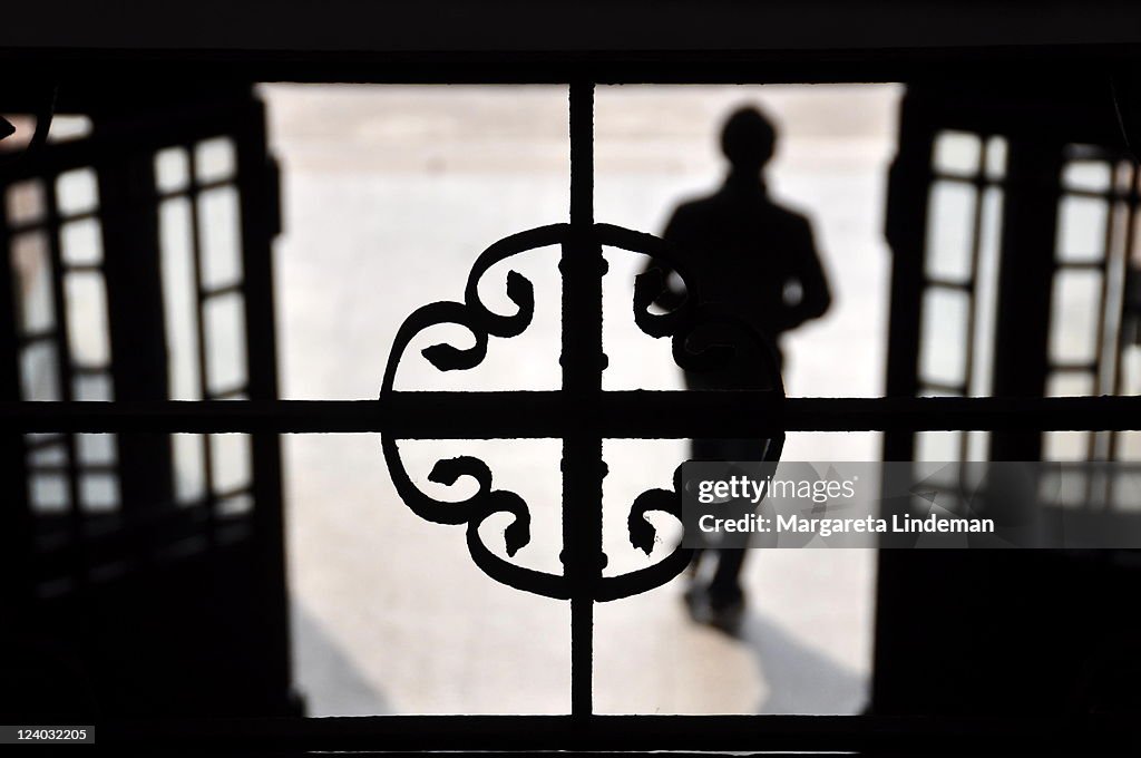 Young man walking through open door into light