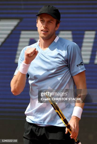 Netherlands' Botic van de Zandschulp reacts as he plays against Norway's Casper Ruud during their men's singles quarter-final match of the ATP Tennis...