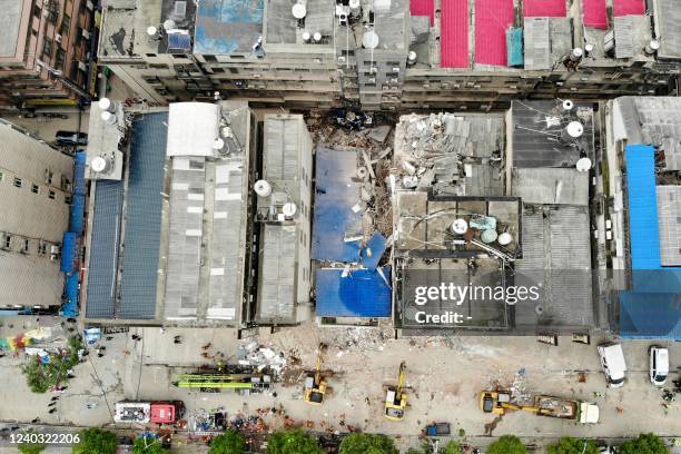 This aerial photograph taken on April 29, 2022 shows rescuers working after a six-storey building collapsed in Changsha, in China's central Hunan...