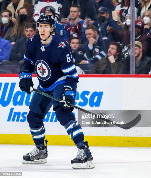 Logan Stanley of the Winnipeg Jets keeps an eye on the play during first period action against the Colorado Avalanche at Canada Life Centre on April...