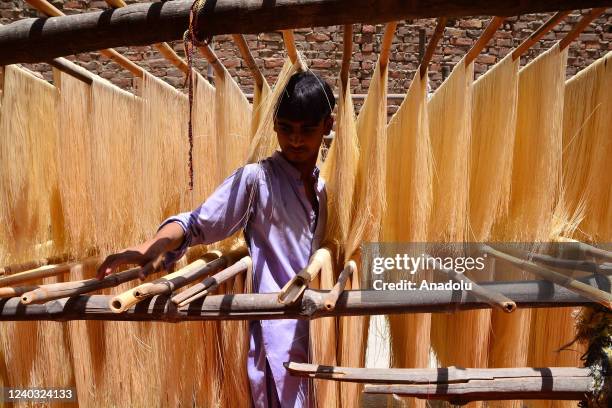 Pakistani people place vermicelli in open space for drying which is traditionally used as sweet dish ahead of Eid al-Fitr in Hyderabad, Pakistan on...