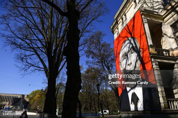 Banner depicting Russian President Vladimir Putin and protesting against the war in Ukraine hangs from a building near the the Embassy of Russia, in...