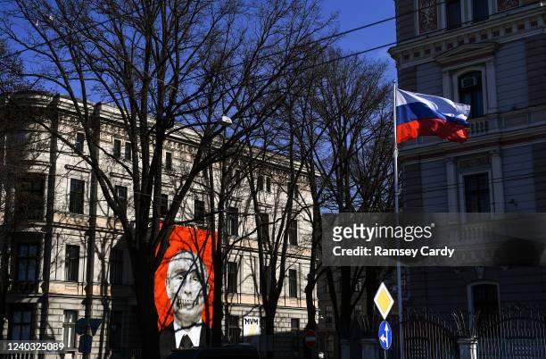 Banner depicting Russian President Vladimir Putin, protesting against the war in Ukraine hangs fron a building near the the Embassy of Russia, in...