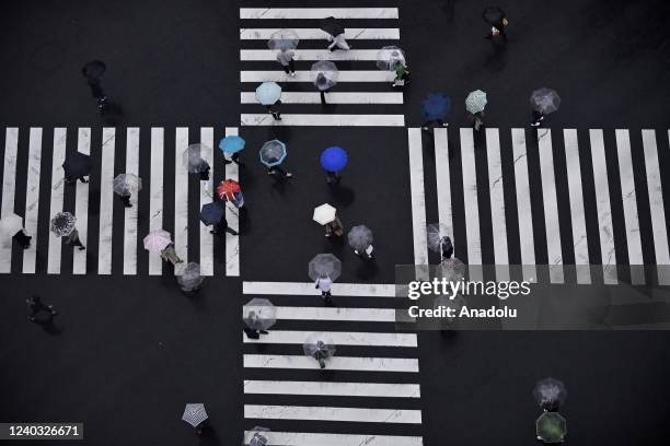 Pedestrians cross a road on April 29, 2022 in Tokyo downtown, Japan, as the 'Golden Week' a series of national holidays starts for a period of 7...