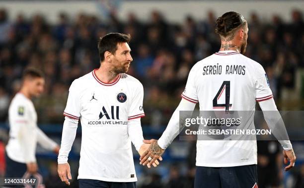 Paris Saint-Germain's Argentinian forward Lionel Messi checks hands with Paris Saint-Germain's Spanish defender Sergio Ramos during the French L1...