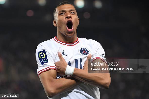 Paris Saint-Germain's French forward Kylian Mbappe celebrates scoring his team's third goal during the French L1 football match between Strasbourg RC...