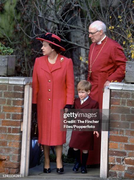 Queen Elizabeth II with her grandson Prince Harry accompanied by the Dean of Windsor, Michael Mann while leaving St George's Chapel after attending...