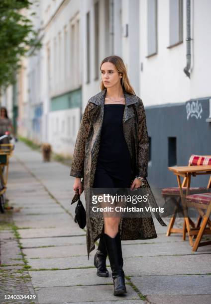 Cheyenne Tulsa is seen wearing rain coat with print Fabien Chapot, black dress Calvin Klein, Zara cowboy boots, Prada bag on June 01, 2020 in Berlin,...