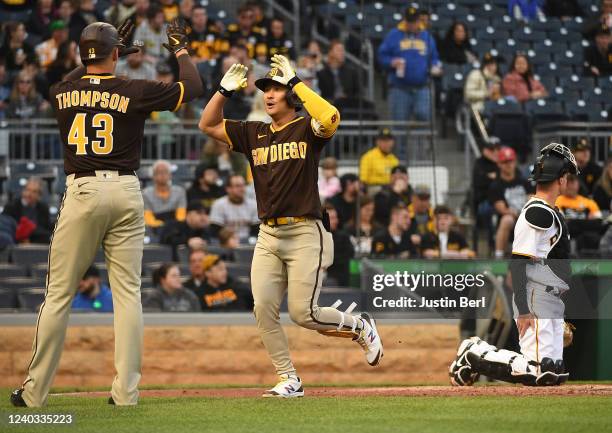 Ha-Seong Kim of the San Diego Padres high fives with Trayce Thompson after hitting a two-run home run in the third inning during the game against the...