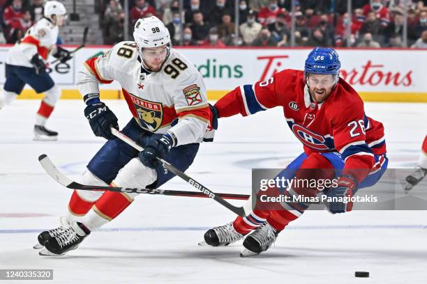 Maxim Mamin of the Florida Panthers skates the puck against Jeff Petry of the Montreal Canadiens during the first period at Centre Bell on April 29,...