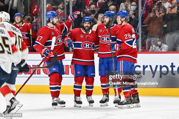 Mathieu Perreault of the Montreal Canadiens celebrates his goal with teammates Josh Anderson, David Savard and Christian Dvorak of the Montreal...