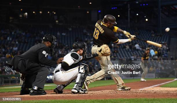 Manny Machado of the San Diego Padres hits a run scoring sacrifice fly ball to center field in the fifth inning during the game against the...