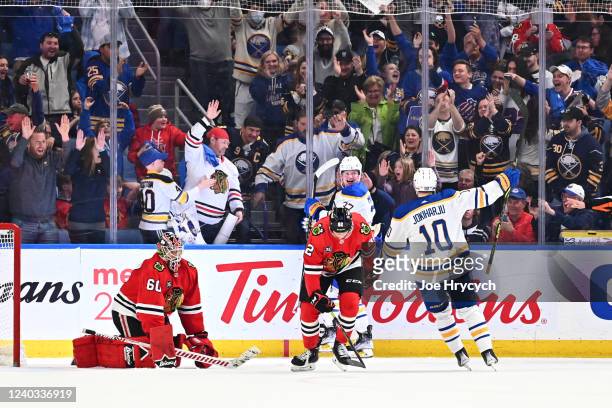 Casey Mittelstadt celebrates his overtime goal with Henri Jokiharju of the Buffalo Sabres against Collin Delia of the Chicago Blackhawks during an...