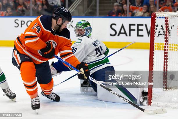 Goaltender Spencer Martin of the Vancouver Canucks defends his net against Devin Shore of the Edmonton Oilers during the second period at Rogers...