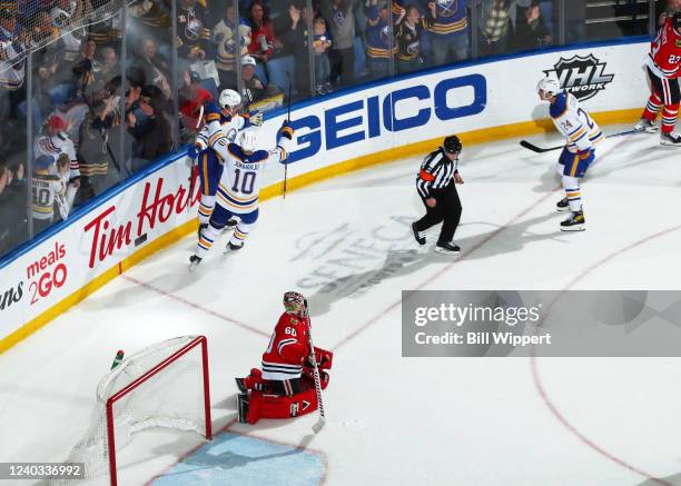 Casey Mittelstadt of the Buffalo Sabres celebrates his overtime winning goal with Henri Jokiharju against Collin Delia of the Chicago Blackhawks...