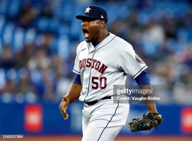 Hector Neris of the Houston Astros celebrates after getting the final out in the ninth inning during a MLB game against the Toronto Blue Jays at...