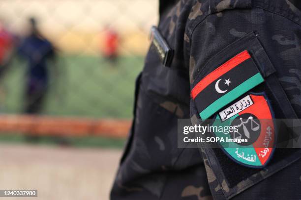 The logo of the judicial police in Libya is seen on the prison guard's sleeve during the Ramadan league organized by the Reform and Rehabilitation...