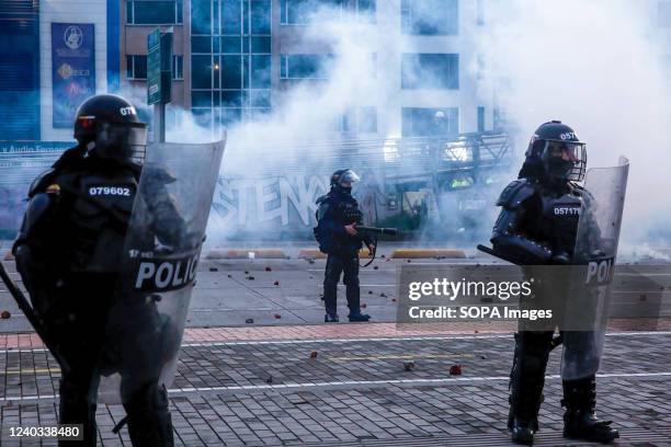 Riot police on guard with police shields during the demonstration. Students clashed heavily with riot police at BogotÃ¡ university as they marched to...