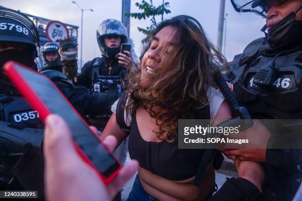 Female protester is being arrested by Riot police during the demonstration. Students clashed heavily with riot police at BogotÃ¡ university as they...
