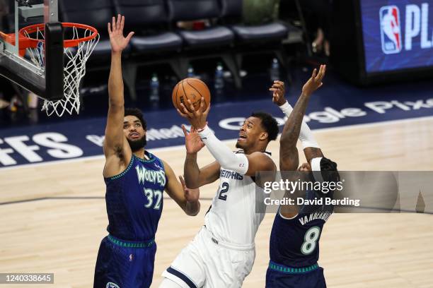 Xavier Tillman of the Memphis Grizzlies goes up for a shot while Karl-Anthony Towns and Jarred Vanderbilt of the Minnesota Timberwolves defend in the...