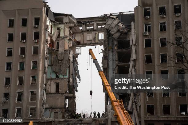 Workers remove rubble from the Mykolaiv Regional State Administration building where at least 35 were killed in a Russian cruise missile attack on...