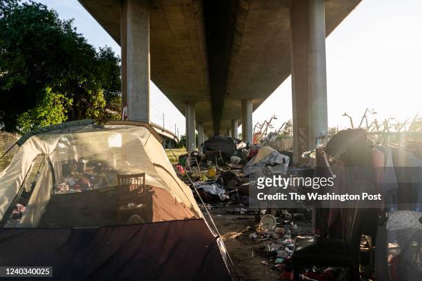 Homeless encampments of tents hidden underneath Route I-80 along Roseville Road in Sacramento, California Wednesday March 30, 2022.