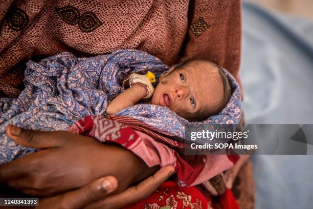 Day-old baby girl born to a an Ethiopian teenager, who says she is unable to feed her because of the drought. People from across Gedo in Somalia have...