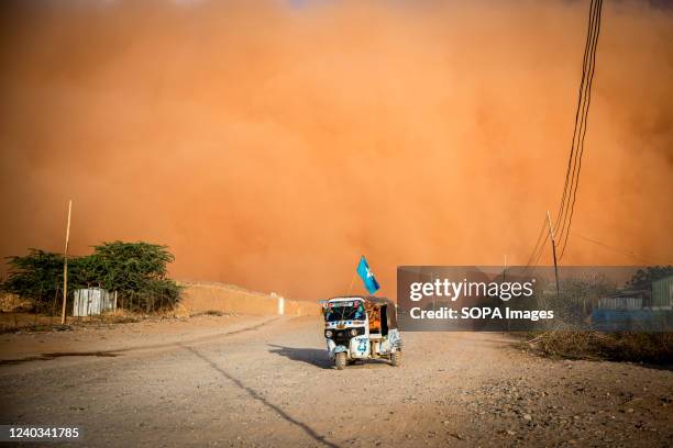 Tuktuk with a Somali flag drives during a sandstorm in Dollow, Jubaland, southwest Somalia. People from across Gedo in Somalia have been displaced...