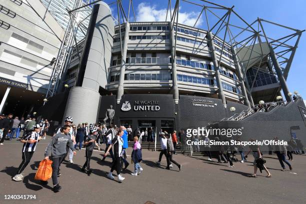Fans mingle outside the stadium before the Premier League match between Newcastle United and Liverpool at St. James' Park on April 30, 2022 in...