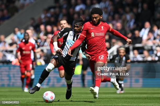 Newcastle United's French midfielder Allan Saint-Maximin fights for the ball with Liverpool's English defender Joe Gomez during the English Premier...