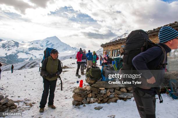 Trekkers rest at a tea house en route to the Thorung Pass on the Annapurna Circuit, Nepal. Climbing to 5,416 meters, the Circuit and is one of the...