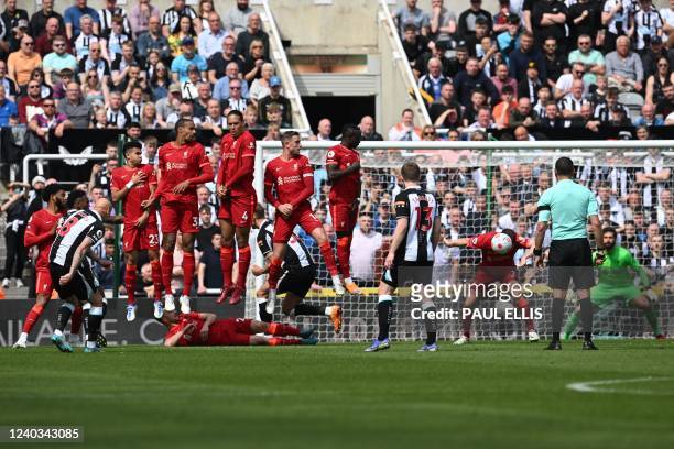 Liverpool's English midfielder James Milner heads the ball shot by Newcastle United's English midfielder Jonjo Shelvey in a free kick during the...