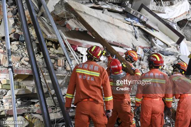 This photo taken on April 29, 2022 shows rescuers searching for survivors at a collapsed six-storey building in Changsha, central Chinas Hunan...