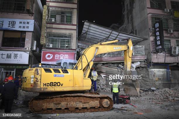 This photo taken on April 29, 2022 shows rescuers searching for survivors at a collapsed six-storey building in Changsha, central Chinas Hunan...