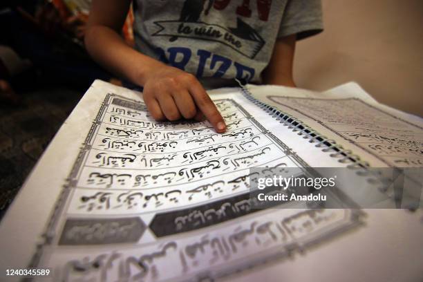 Student recites holy Quran at a madrassa before 'Iftar' in the holy month of Ramadan in Srinagar on April 30, 2022.