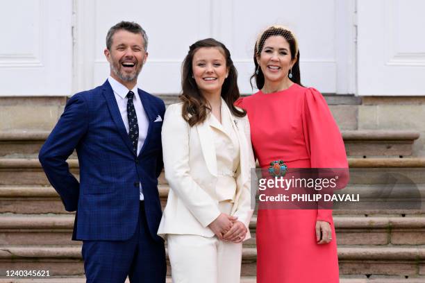 Princess Isabella poses with her parents Crown Prince Frederik of Denmark and Crown Princess Mary of Denmark in front of the palace after Princess...
