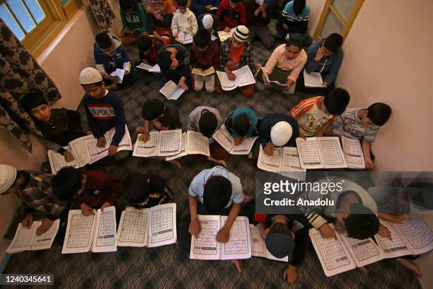 Students attend Quran classes at a madrassa before breaking the fast in the holy month of Ramadan in Srinagar on April 30, 2022.