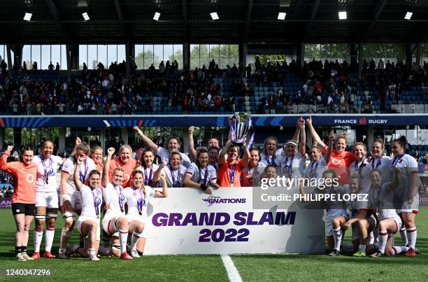 English team poses with the trophy as they celebrate their Grand Slam victory after winning the Six Nations international women's rugby union match...