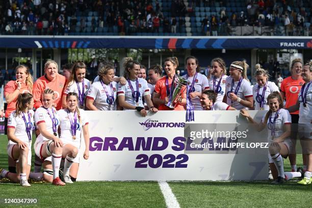English team poses with the trophy as they celebrate their Grand Slam victory after winning the Six Nations international women's rugby union match...