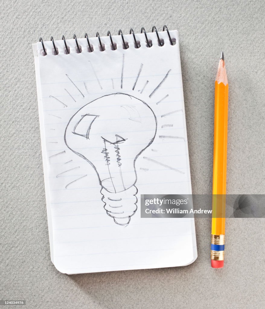 Light bulb sketched on notepad