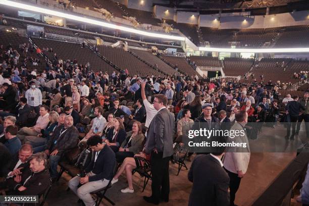 Attendees find their seats during the Berkshire Hathaway annual meeting in Omaha, Nebraska, U.S., on Saturday, April 30, 2022. After hanging in the...
