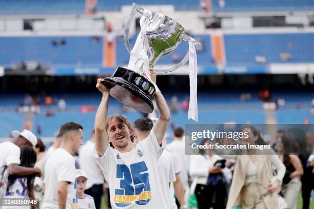 Luka Modric of Real Madrid celebrates the championship with the trophy during the La Liga Santander match between Real Madrid v Espanyol at the...