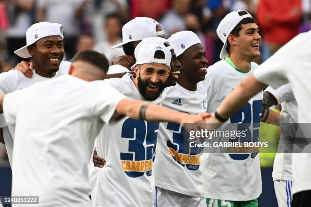 Real Madrid's French forward Karim Benzema and teammates celebrate at the end of the Spanish League football match between Real Madrid CF and RCD...