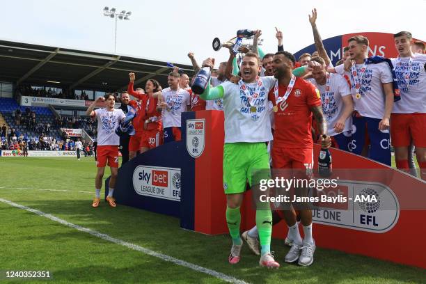 Wigan Athletic players celebrate winning the Sky Bet League One and winning promotion to the Championship after the Sky Bet League One match between...