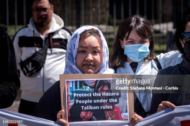 Protestor holds a placard that reads Protect the Hazara People under the Taliban rules during "Stop Hazara genocide" demonstration by the Hazara...