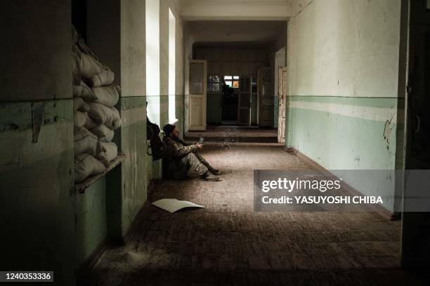 Ukrainian soldier rests at an abandoned building after fighting on the front line for two months near Kramatorsk, eastern Ukraine on April 30, 2022....