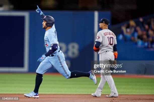 George Springer of the Toronto Blue Jays runs out a solo home run in the first inning of their MLB game against the Houston Astros at Rogers Centre...